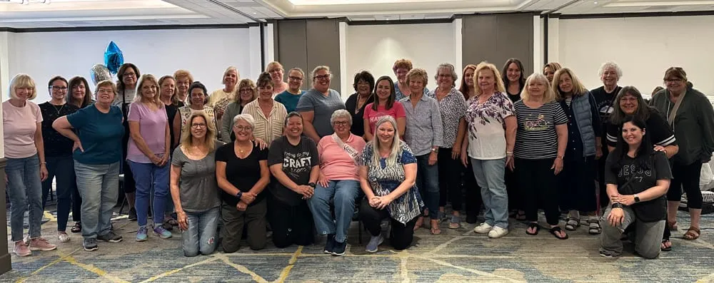 The whole crop gathered for a group photo in the hotel ballroom, forty-odd retreat-goers in three rows with a blue balloon behind them